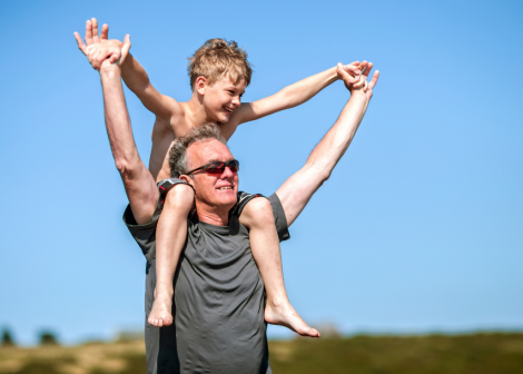 Grandpa carrying his grandson on his shoulders